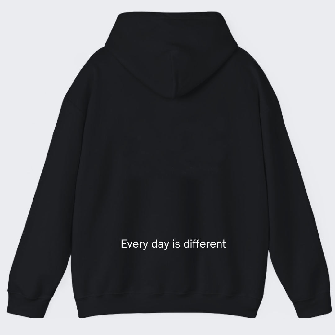 Back view of Healing Hearts black hoodie featuring ‘Every day is different’ embroidery