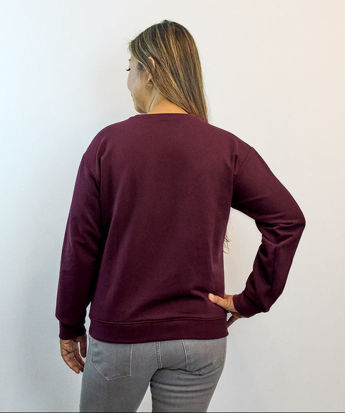 Back view of raspberry Heart Sweater featuring embroidered design — sustainable comfort clothing for everyday calm and healing.