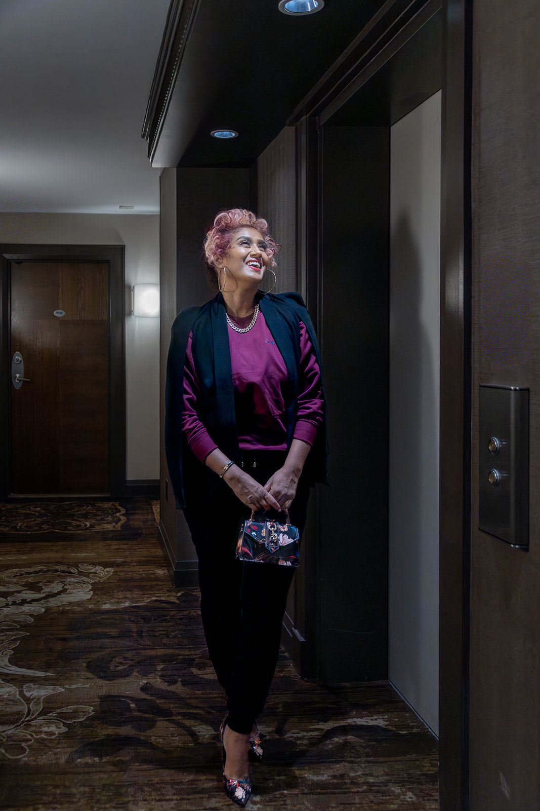 woman by an elevator wearing Heart Sweaters—simple, elevated comfort for going out.