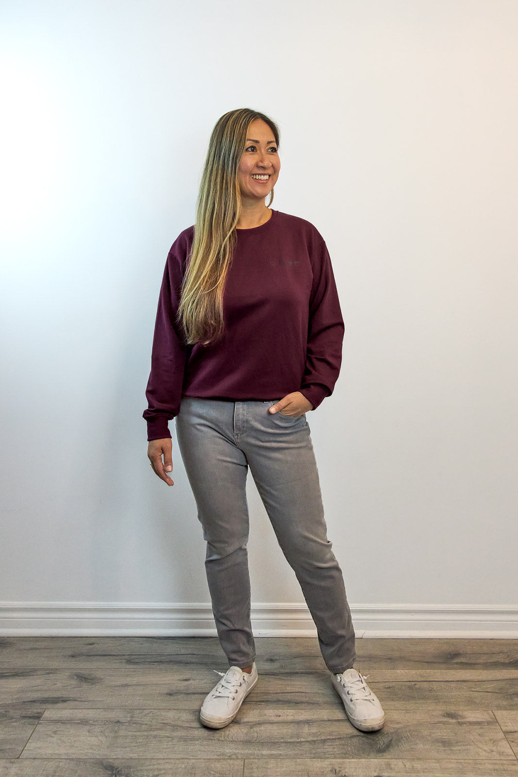 Woman wearing Heart Sweater with four embroidered hearts, symbolizing that every emotion is valid — sustainable comfort clothing by HeartWear Co.