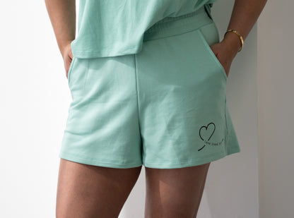 Pistachio green Love Loungewear shorts worn by model – soft sustainable bamboo cotton spandex loungewear made in Canada