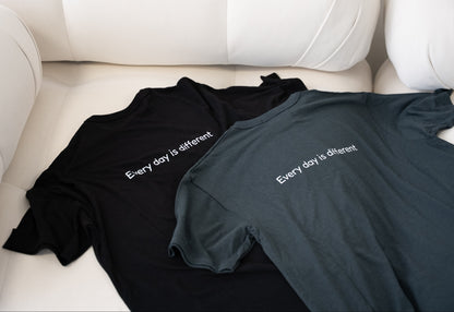 Men’s Healing T-shirts in black and gray lying flat on couch – soft and durable loungewear for men