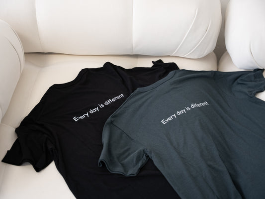Men’s Healing T-shirts in black and gray lying flat on couch – soft and durable loungewear for men