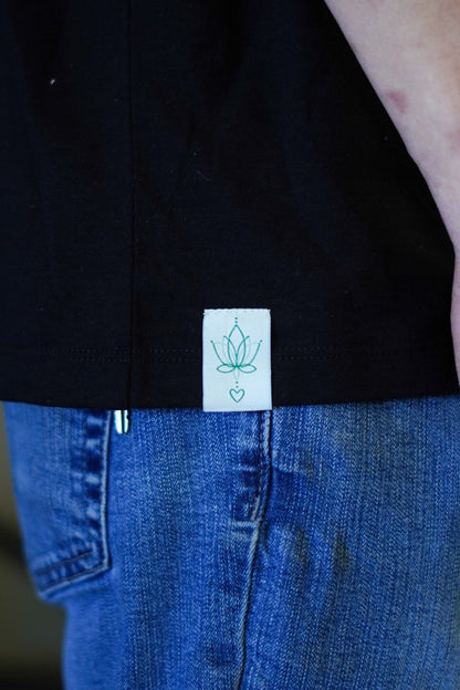 Close-up of hand tag on Men’s Healing T-shirt – sustainable bamboo cotton spandex fabric